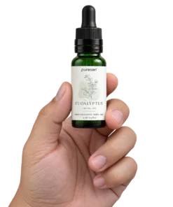 Puresen Eucalyptus 15 ml Aroma Oil held naturally between the fingers of an adult hand