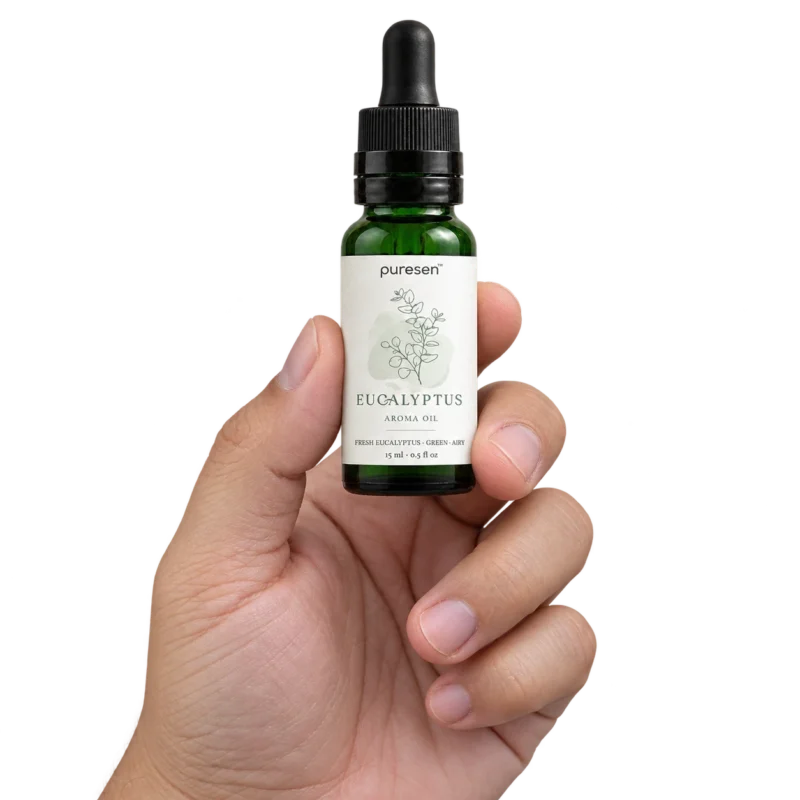 Puresen Eucalyptus 15 ml Aroma Oil held naturally between the fingers of an adult hand
