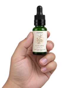 Puresen Ginger 15 ml Aroma Oil held naturally between the fingers of an adult hand