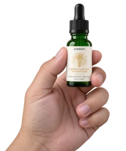 Puresen Lemongrass Daydream 15 ml Aroma Oil held naturally between the fingers of an adult hand