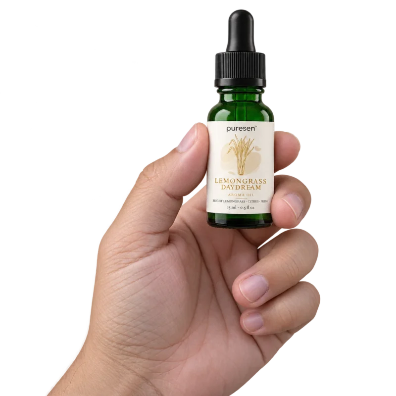Puresen Lemongrass Daydream 15 ml Aroma Oil held naturally between the fingers of an adult hand