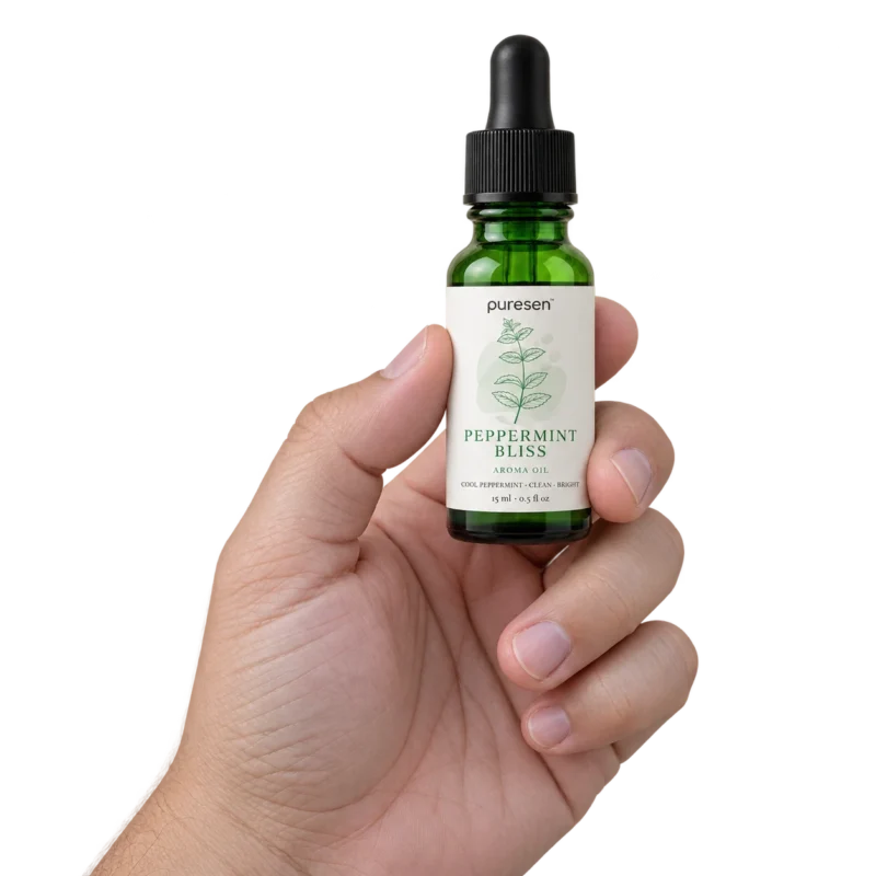 Puresen Peppermint Bliss 15 ml Aroma Oil held naturally between the fingers of an adult hand